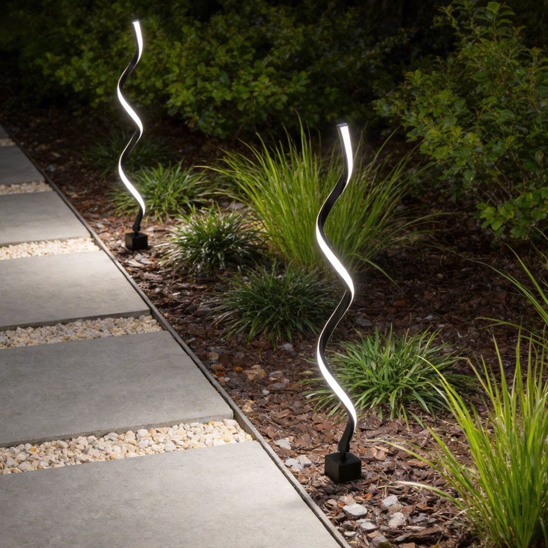 Spiral LED path light enhancing a contemporary garden pathway with soft directional light.