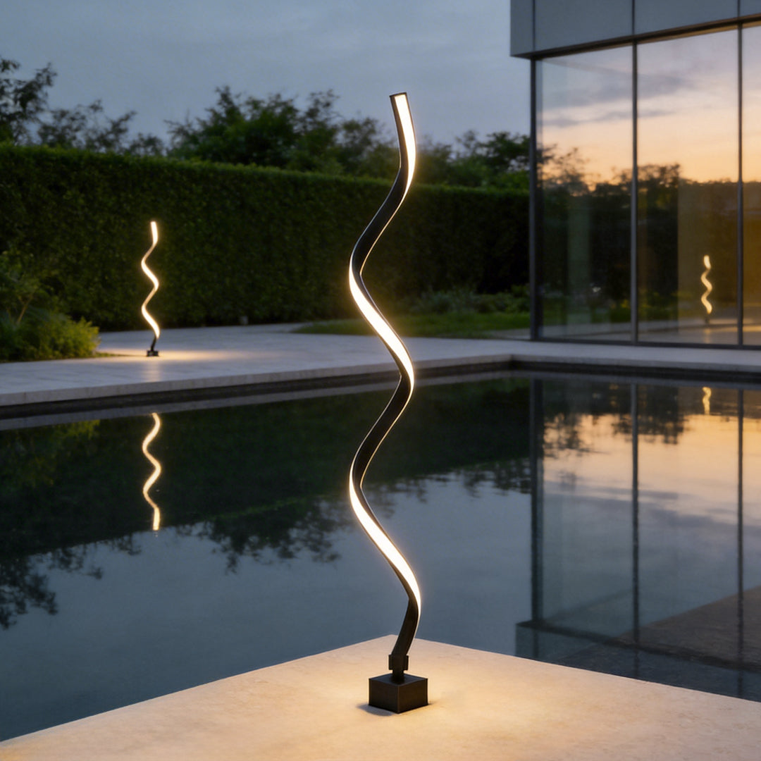 Spiral LED path light illuminating a modern poolside walkway with elegant ambient glow.