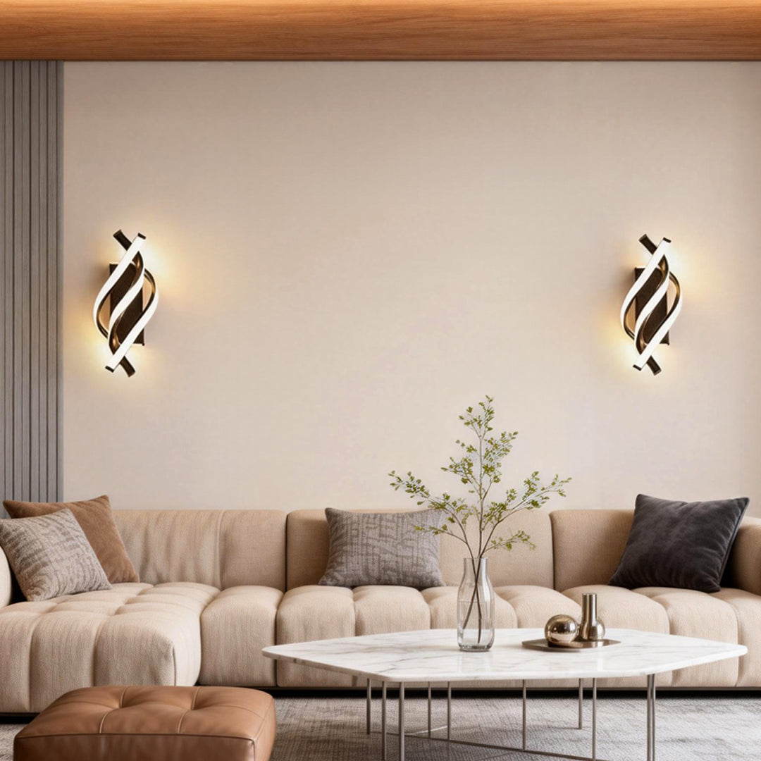 Spiral wall sconce providing soft illumination above a cozy sofa.