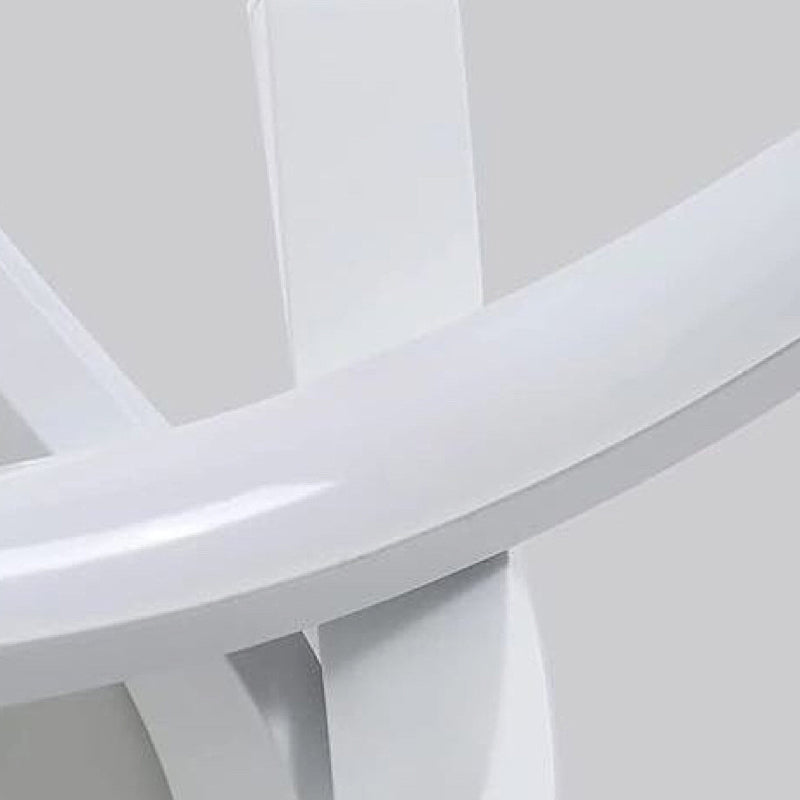 Spiral wall sconce displayed on a white wall, showcasing modern design.