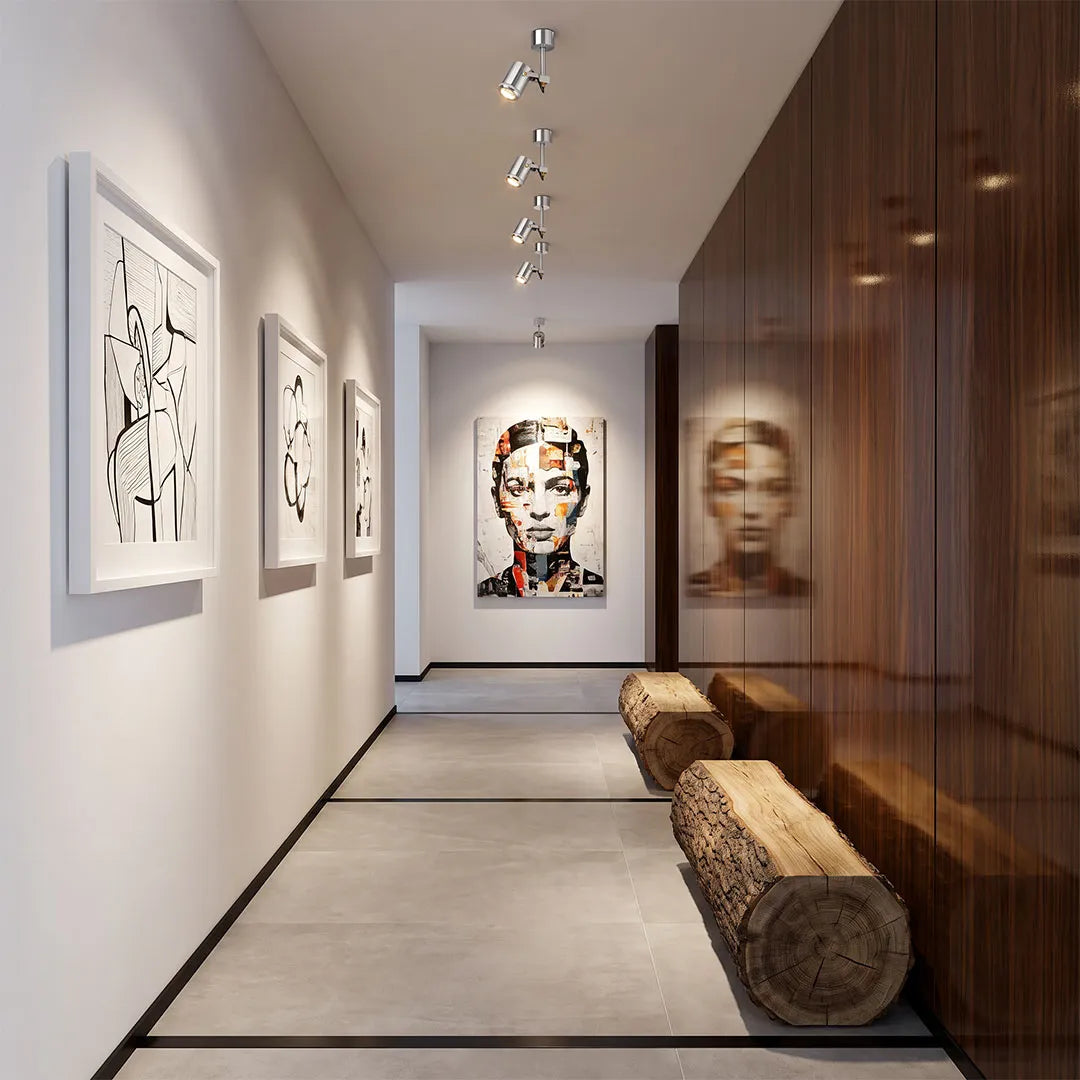 Spotlight ceiling light illuminating artwork in a contemporary gallery-style corridor.