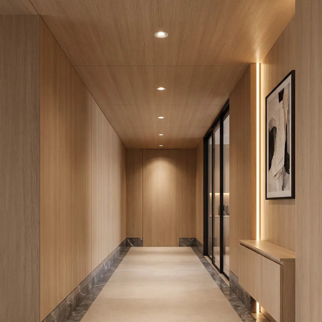 Spotlight ceiling lights installed in a modern wood-paneled hallway with focused illumination.