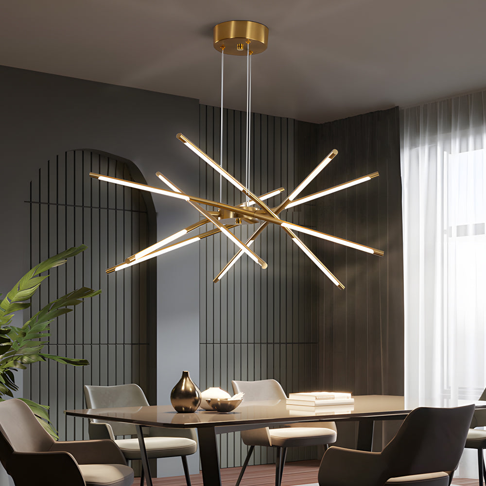 Sputnik chandelier in a gold finish hanging over a dining table in a sleek contemporary room with dark curtains and soft natural light.