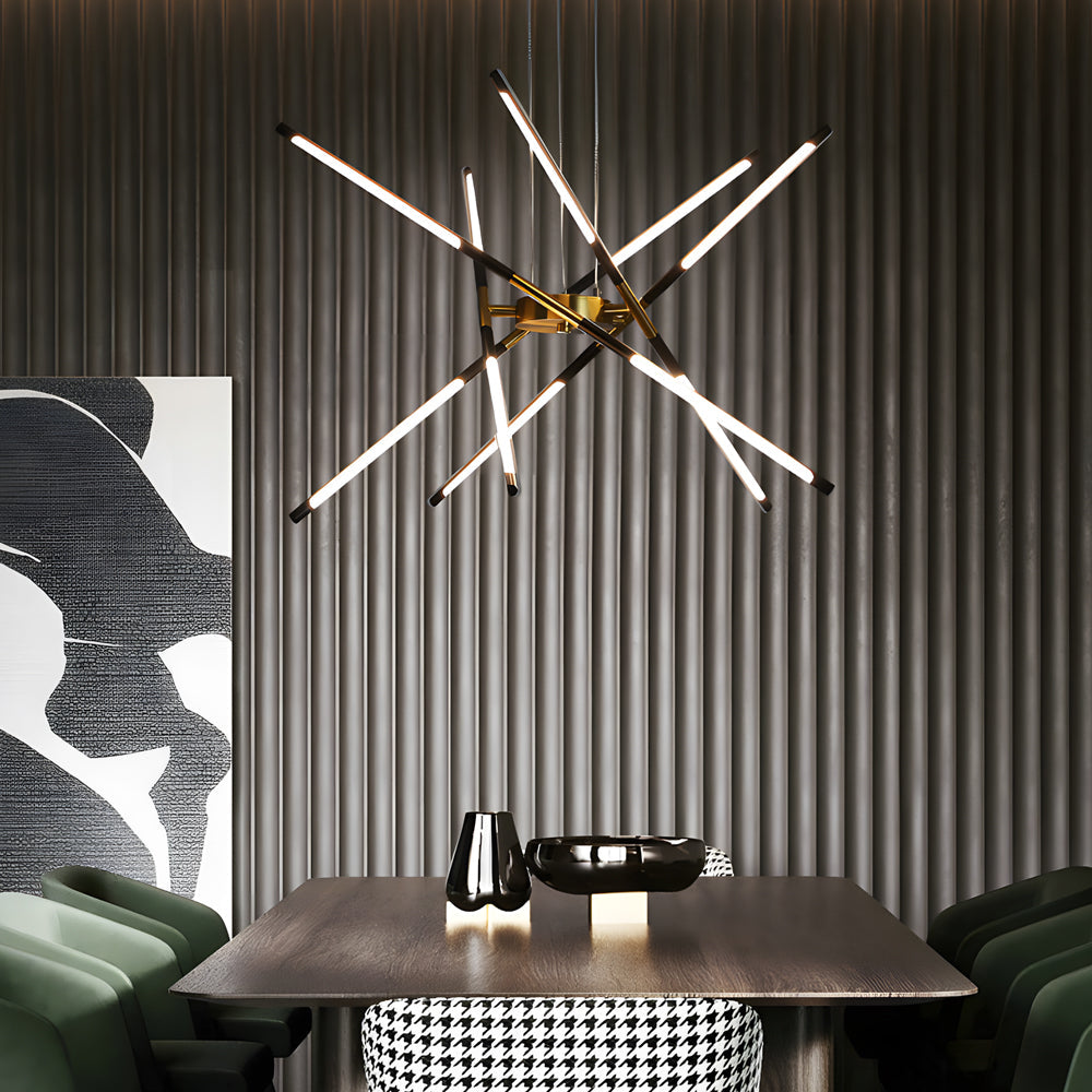Sputnik chandelier with radiant linear arms displayed against a ribbed feature wall above a modern dining table and upholstered green chairs.