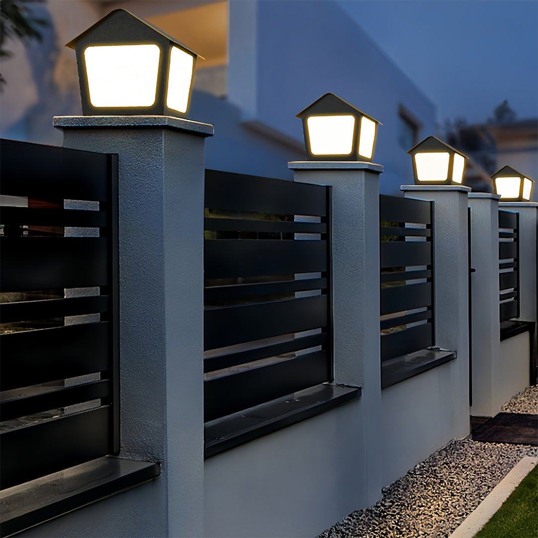 Multiple square deck post cap lights lining a sleek black fence, providing functional and decorative security lighting.