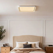 Square flush mount ceiling light installed in a modern bedroom with paneled walls.
