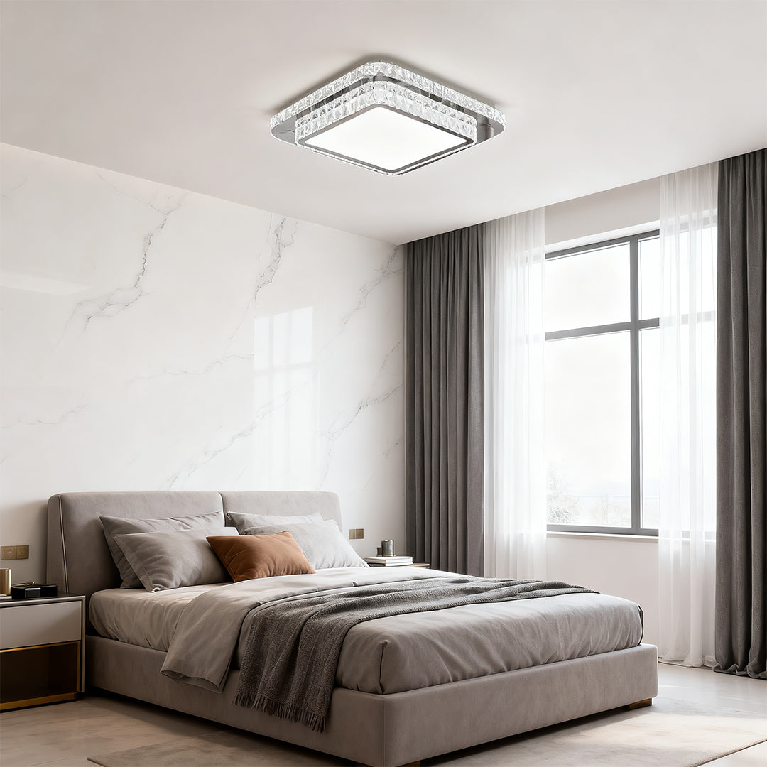 Square flush mount crystal light fixture lighting up a minimalist bedroom.
