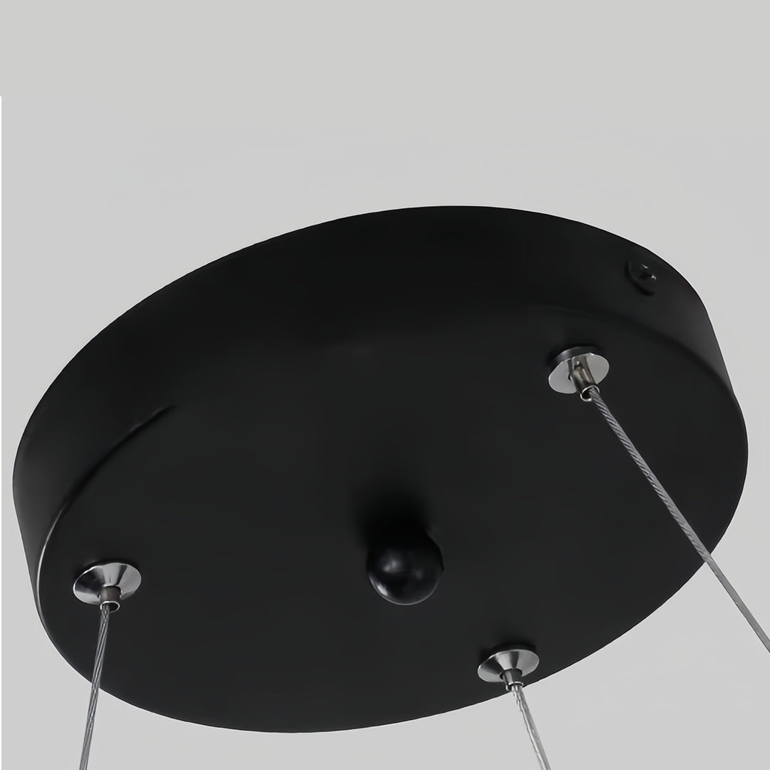 Modern black chandelier with square geometric designs, suspended in a minimalist setting to enhance the ambiance.