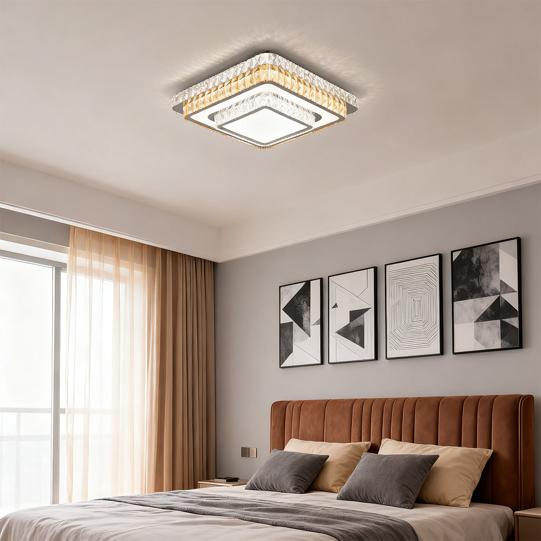 Square modern flush mount light fixture installed above a bed in a contemporary bedroom.