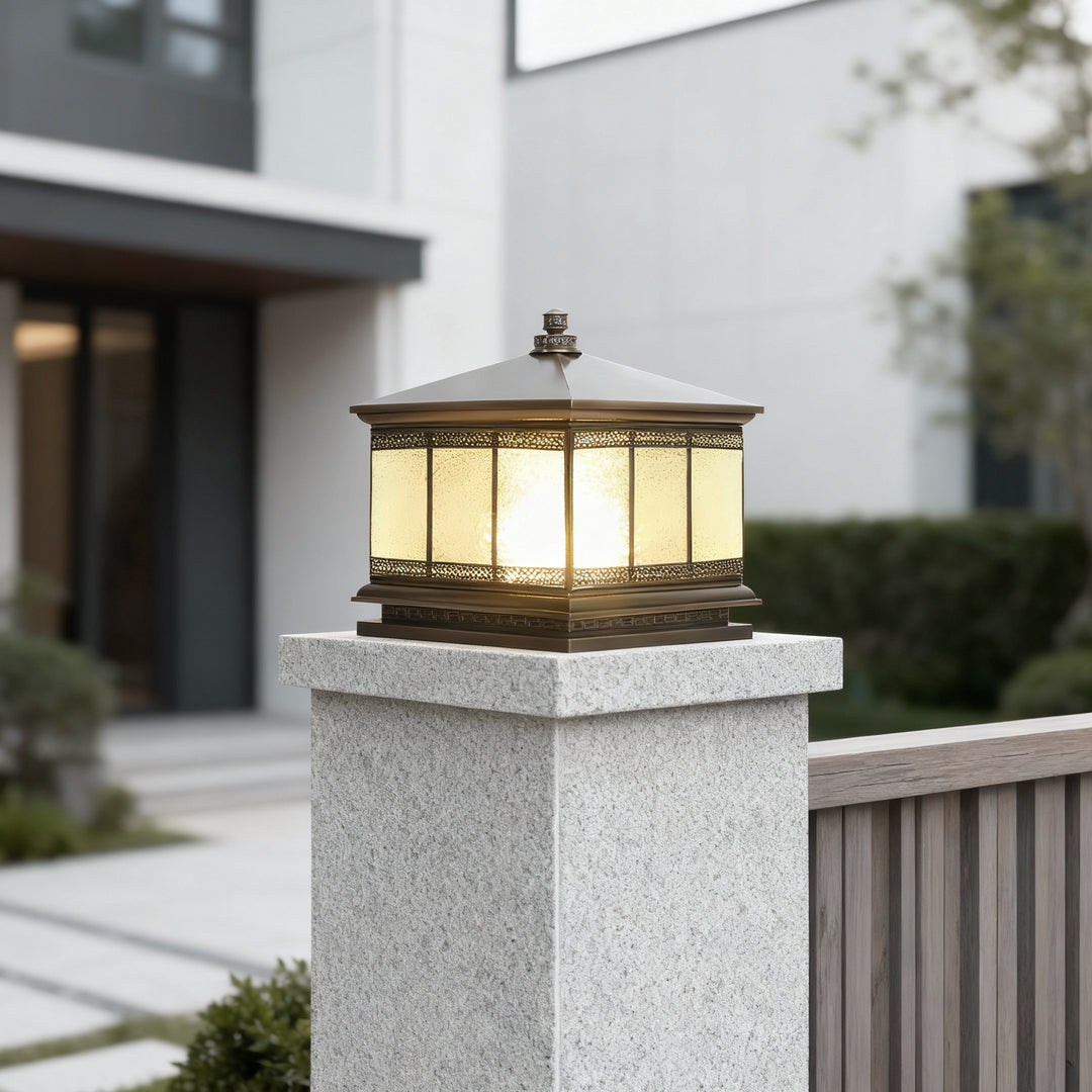 Square outdoor gate pillar light mounted on a concrete column in a contemporary home exterior.