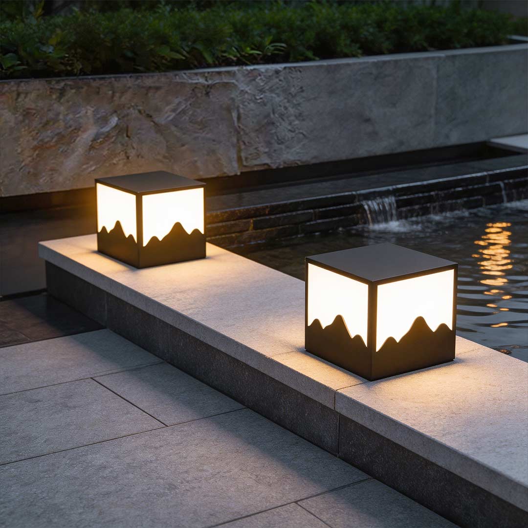 Square outdoor lights illuminating a modern garden pathway with warm mountain-wave design.