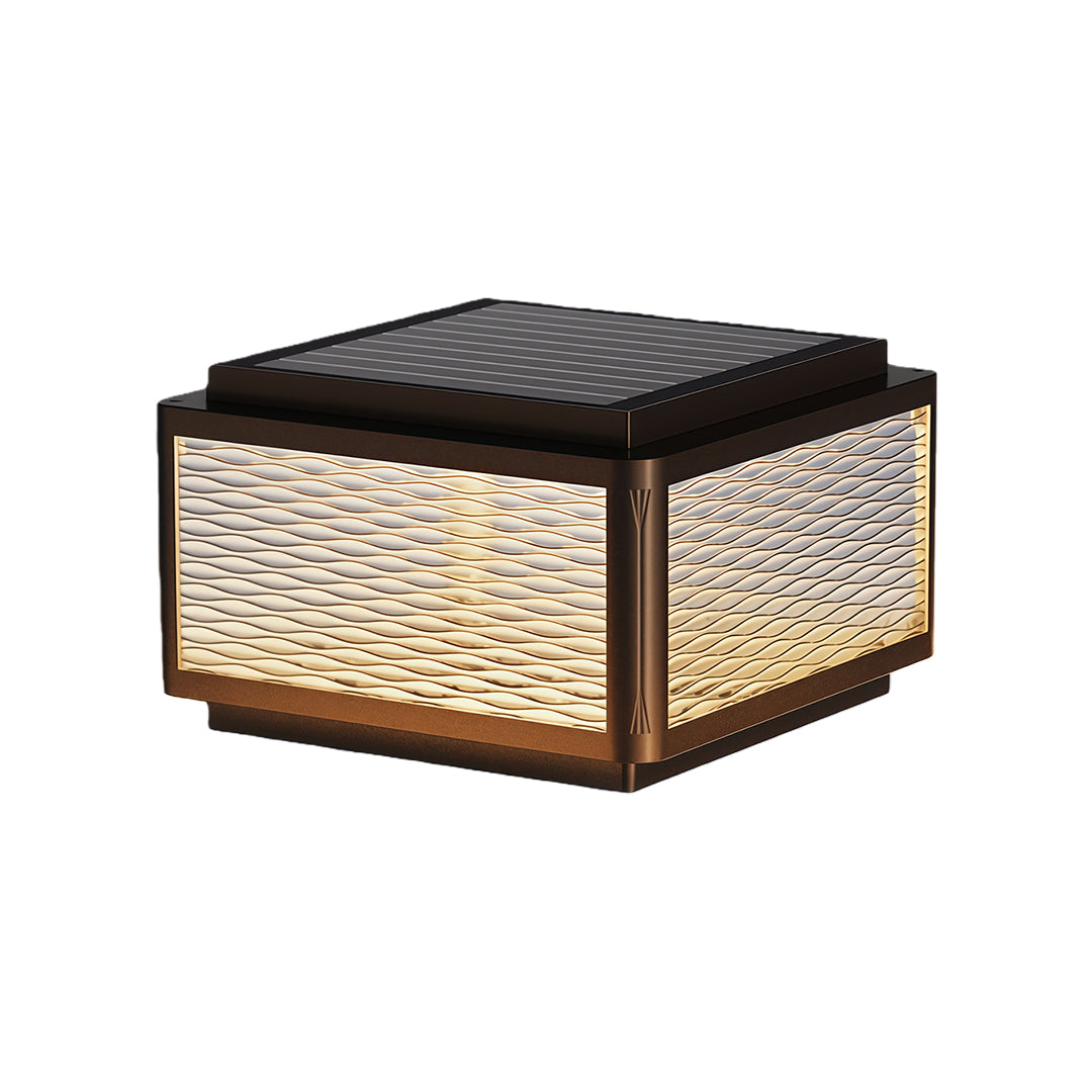 Square outdoor pillar light featuring a minimalist design with a textured top and warm light.