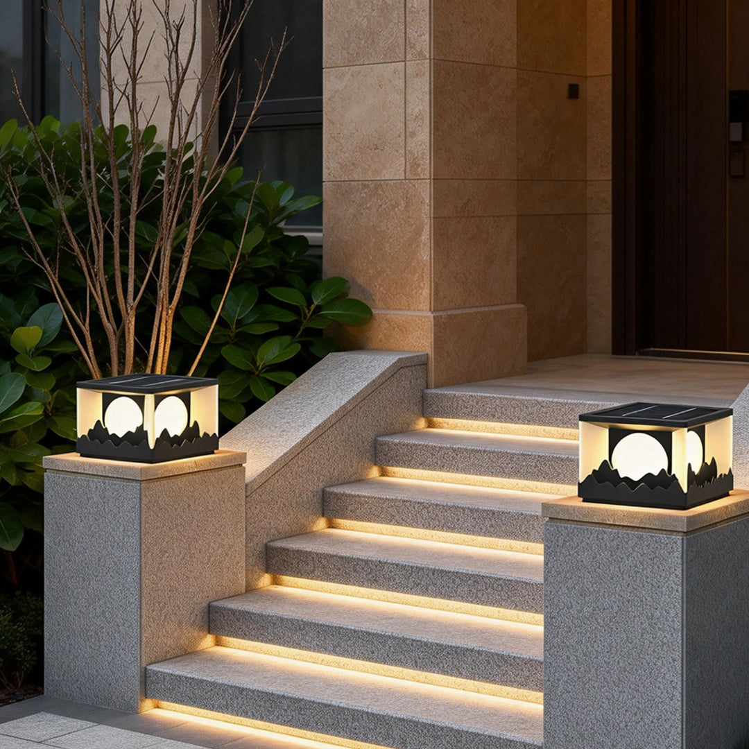 Square outdoor pillar lights illuminating a modern staircase with warm, ambient glow.