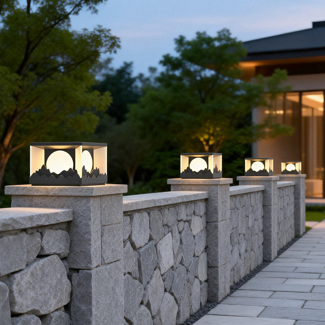 Square outdoor pillar lights providing soft illumination along a garden pathway.