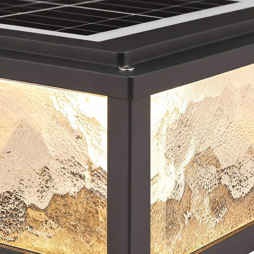 Close up of square outdoor pillar lights showing textured glass and metal frame detail.