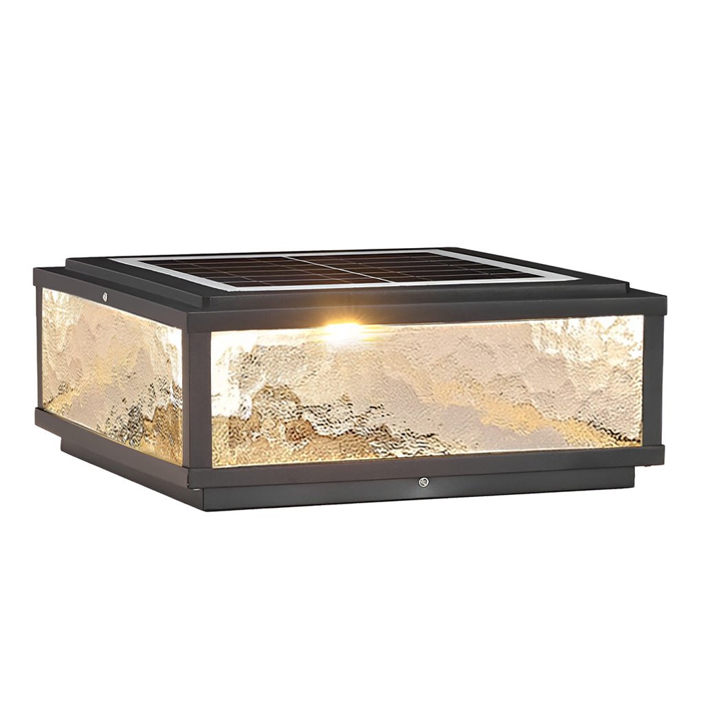 Square outdoor pillar lights illuminated at night showing warm ambient lighting effect.