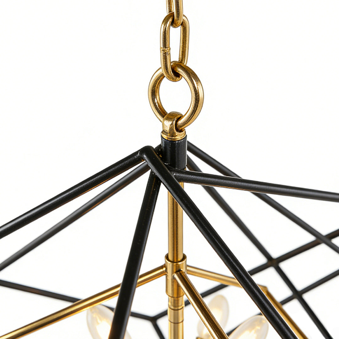 Detail view of square pendant lights showing a black metal frame with gold accents and hanging chain for a modern industrial look.