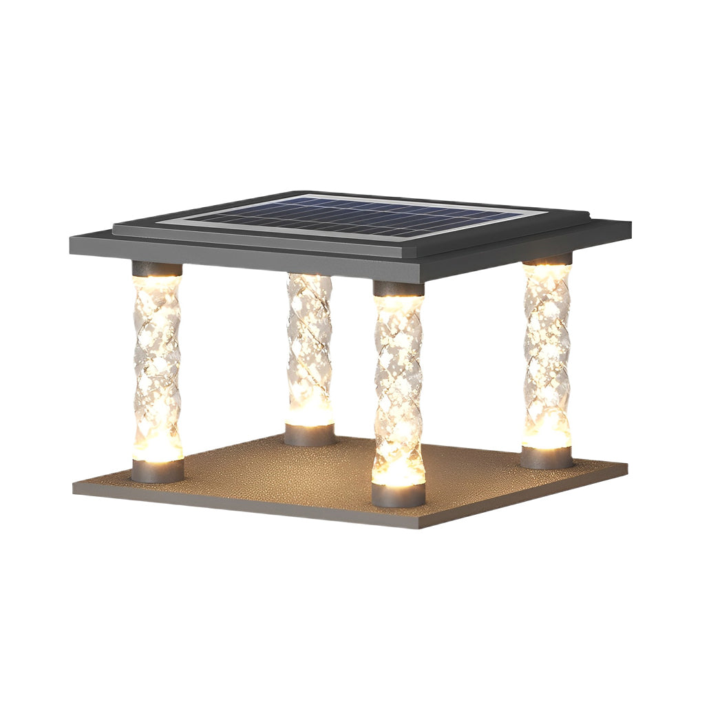 Square pillar lamp with crystal columns, providing warm light near a water feature.