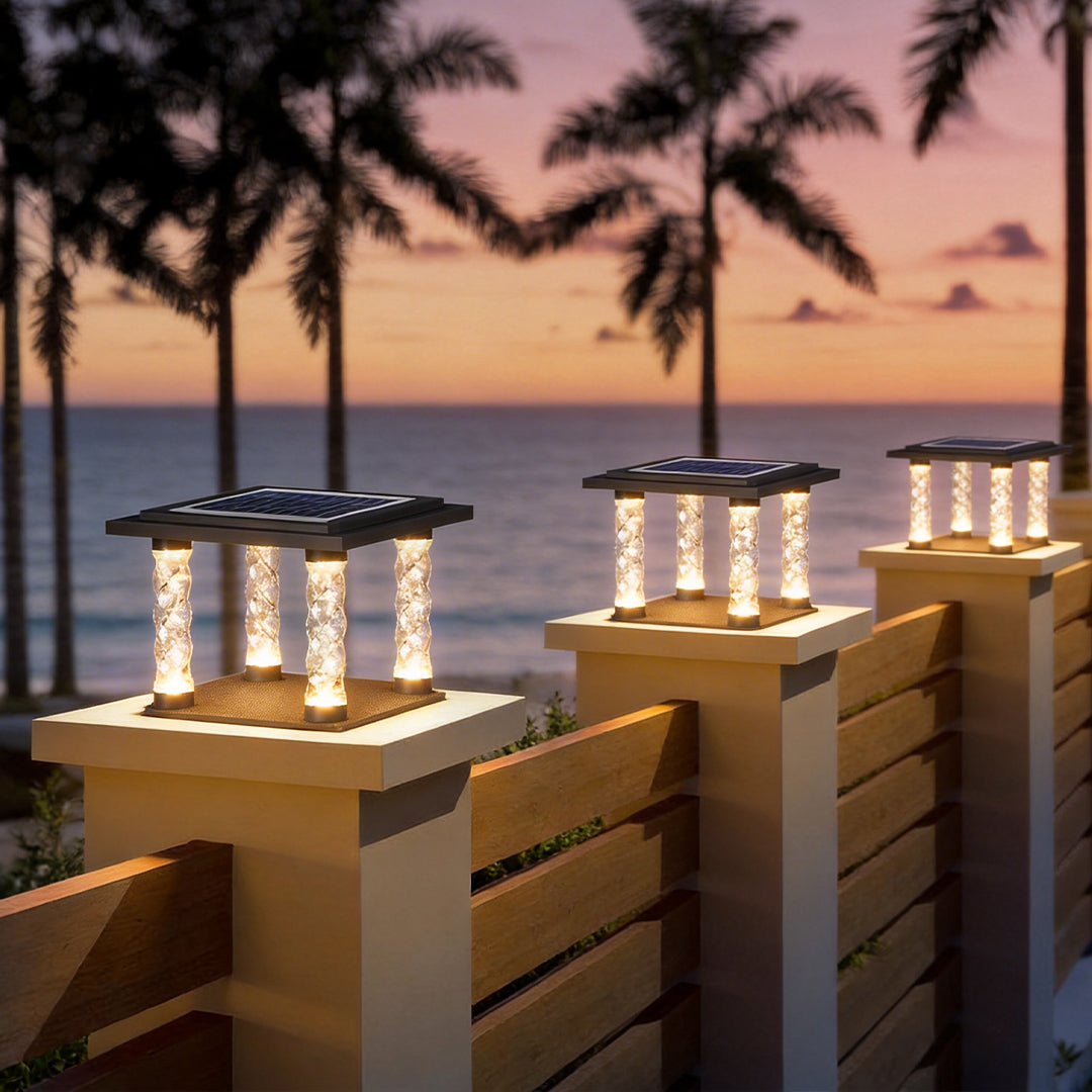 Square pillar lamp with a modern design, enhancing a beachside patio at sunset.
