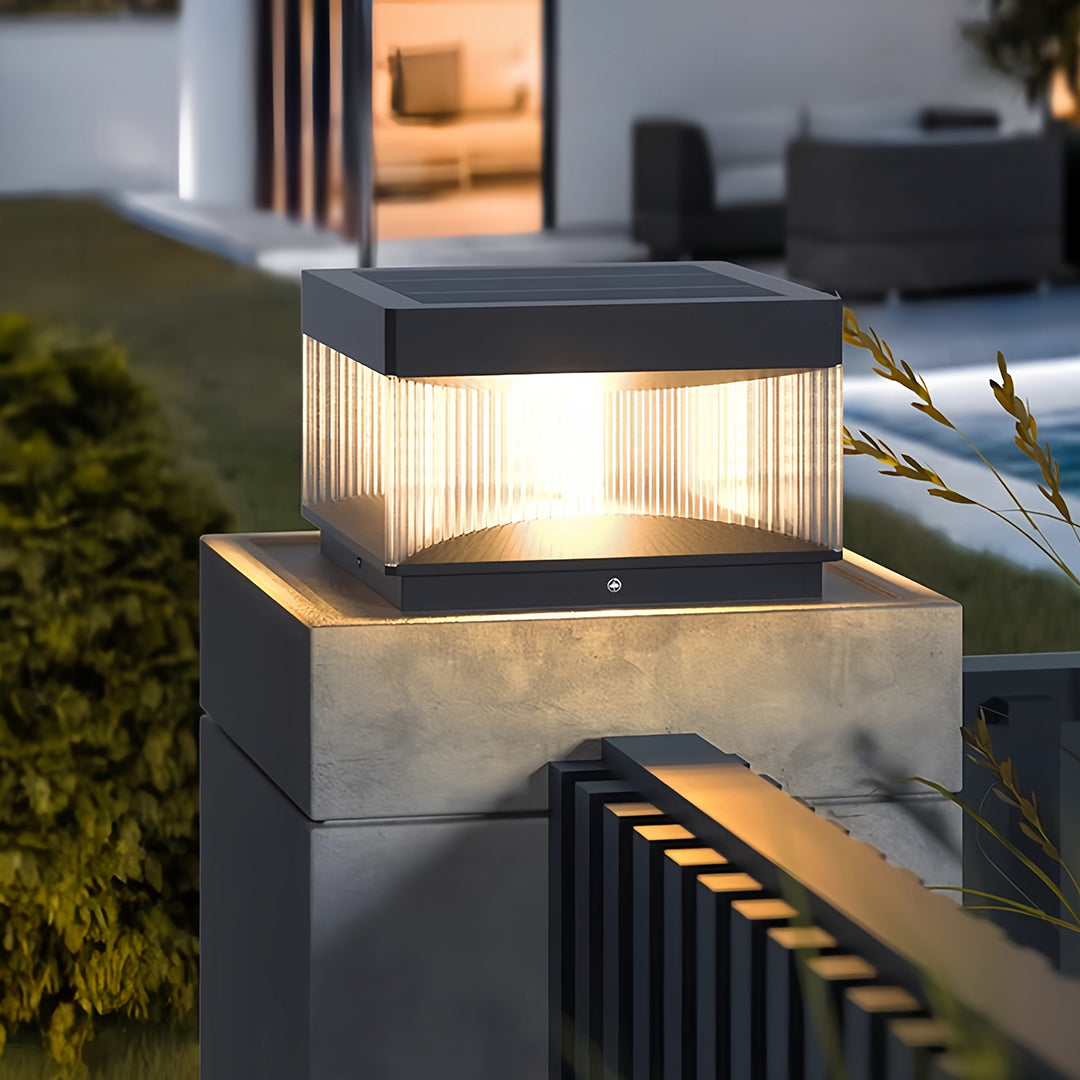 Square pillar lights positioned on architectural post columns with warm illumination effect