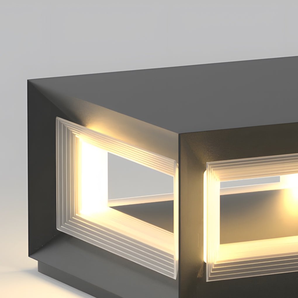 Close-up view of square pillar lights with frosted panels, showing warm LED glow and clean geometric design.