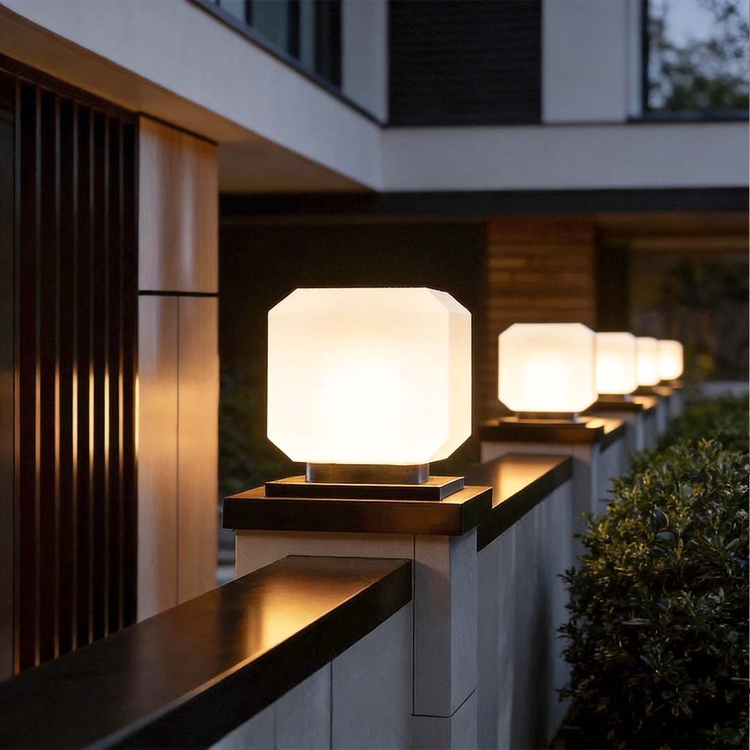 Square pillar lights with a close-up of their illuminated square shape along a pathway.