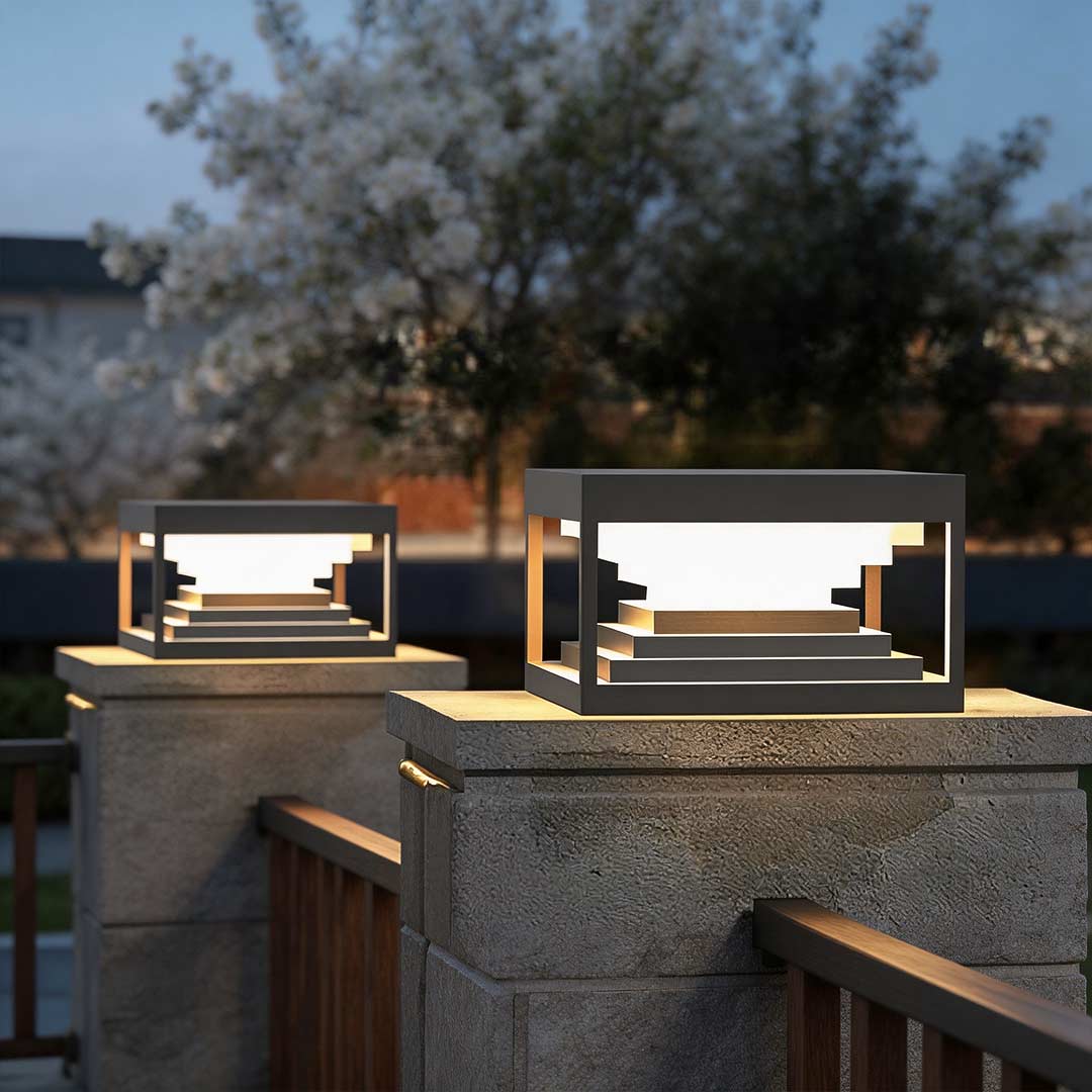 Square pillar lights enhancing a contemporary garden fence with elegant directional light.