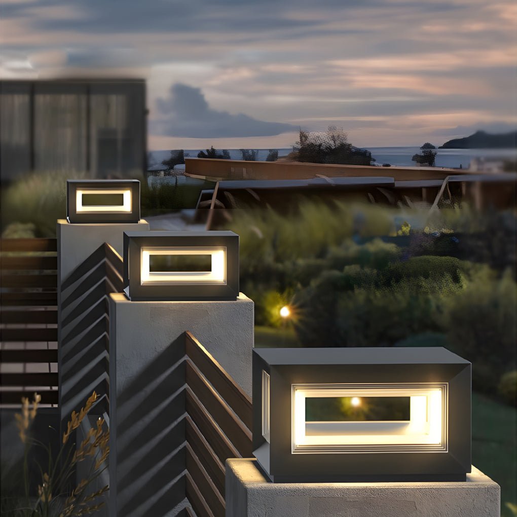 Contemporary square pillar lights installed on layered garden walls, enhancing landscape depth with warm, even lighting.