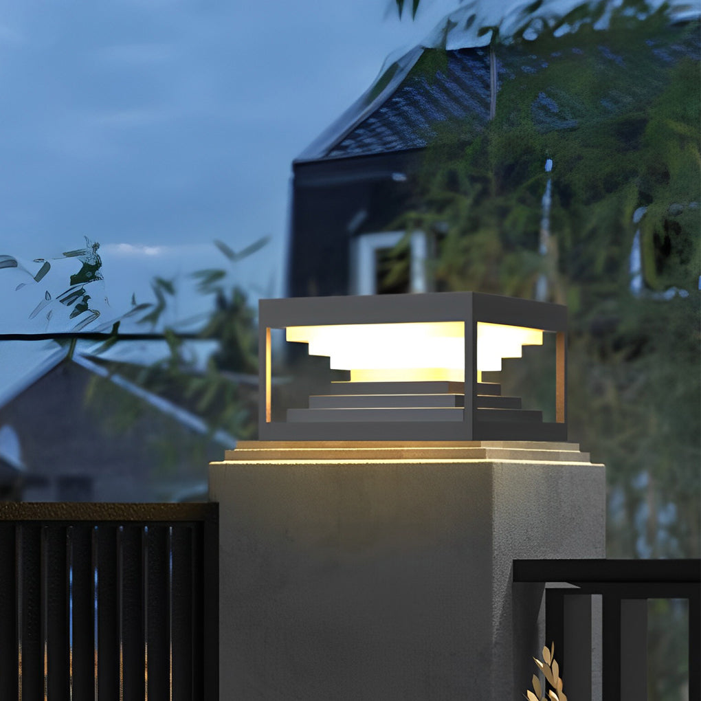 Square pillar lights illuminating a minimalist outdoor entrance with focused glow.