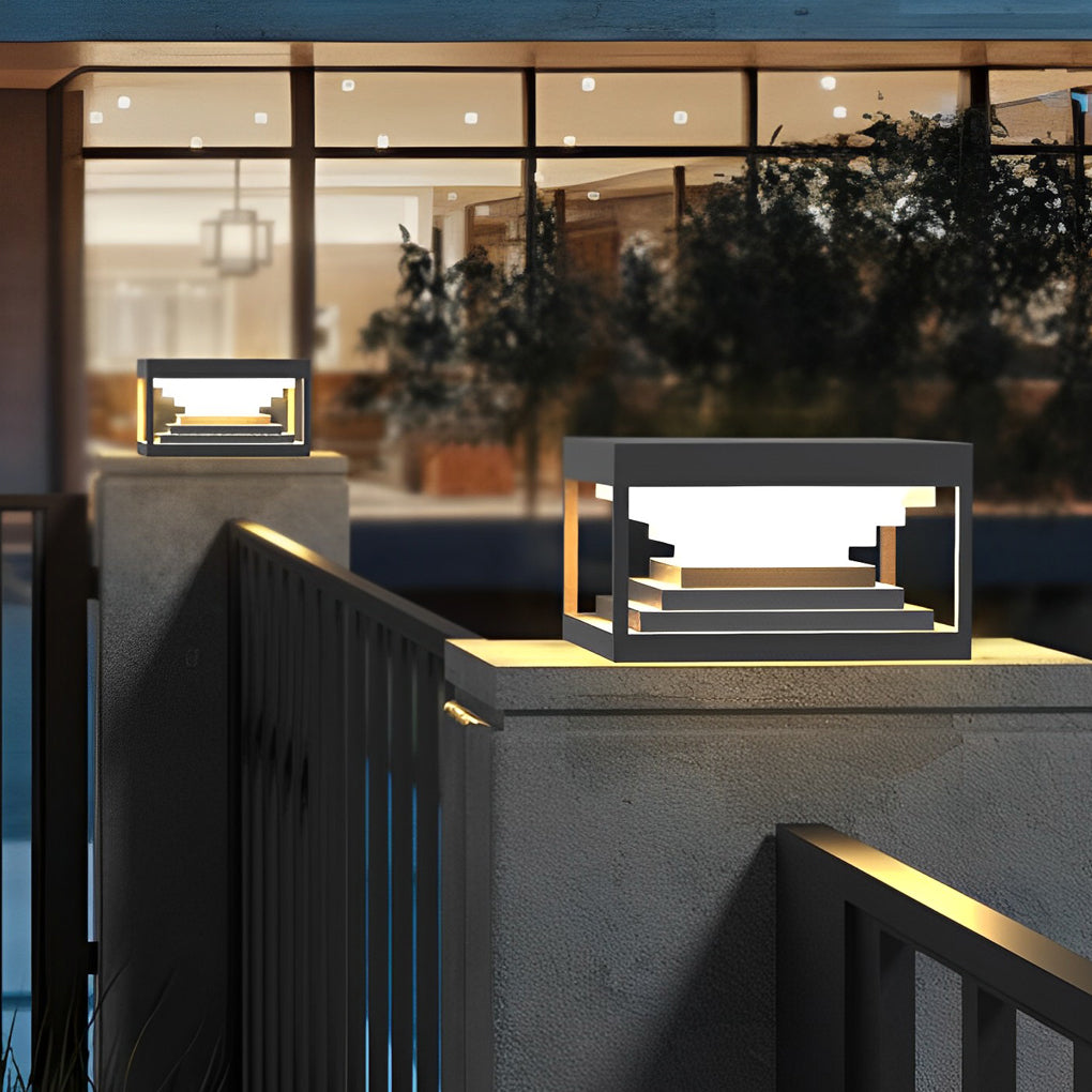 Square pillar lights enhancing a modern outdoor seating area with warm light.