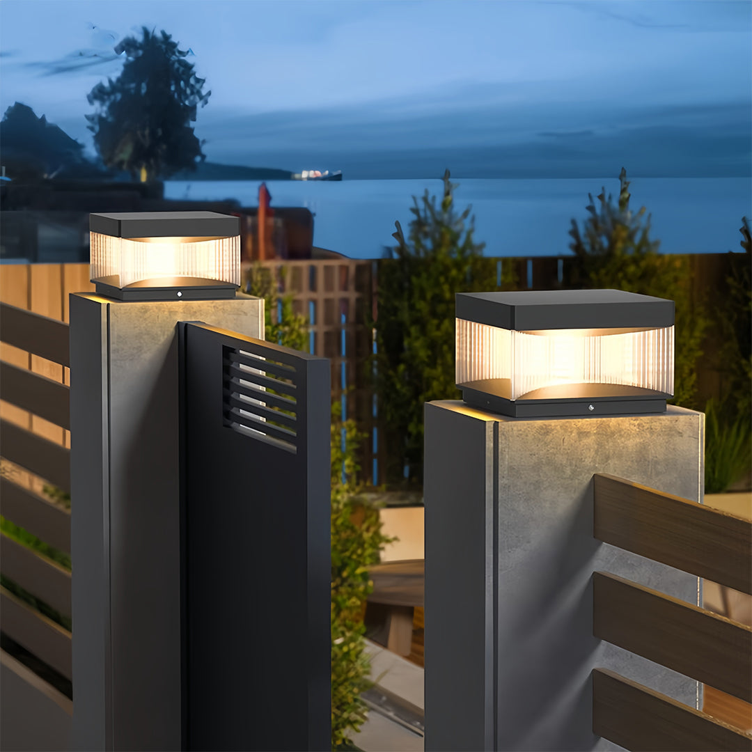 Square pillar lights mounted on modern residential fence creating dramatic evening ambiance