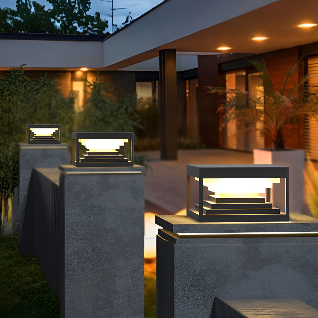 Square pillar lights providing soft illumination along a stylish outdoor pathway.