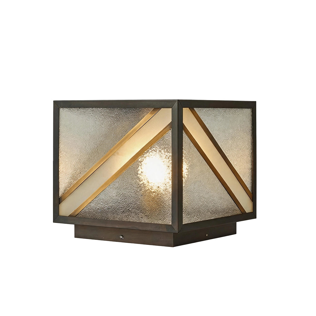 Square solar pillar light with black metal frame gold accents and textured glass