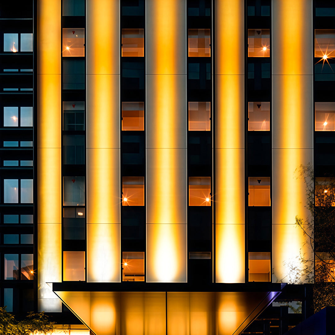 Angled close-up view of square LED wall wash light showing lens array.
