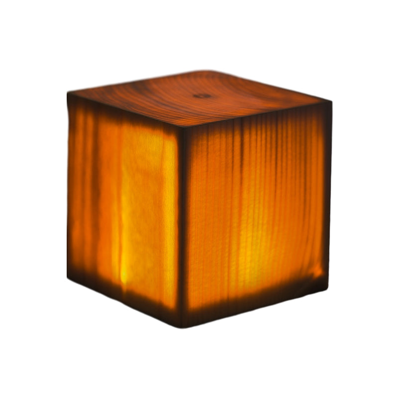 Square wood lamp in cube shape, front view of the illuminated wood.