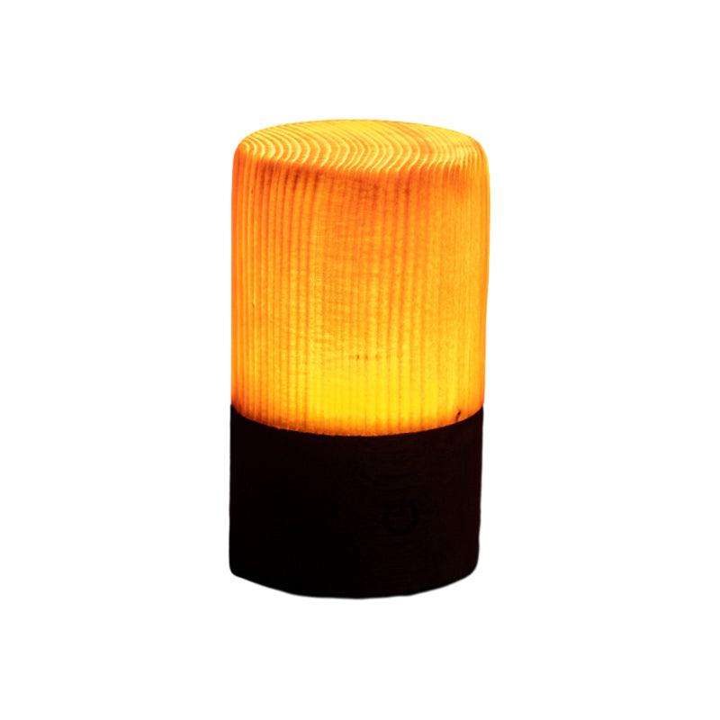Square wood lamp in cylindrical shape, front view of the warm glow.