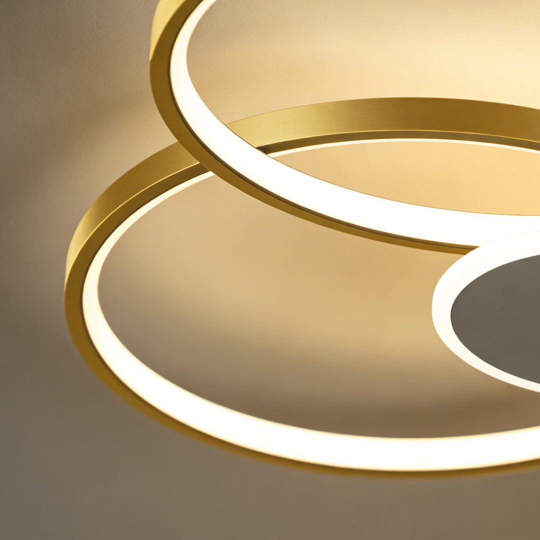 Close-up detail of the illuminated rings on a stacked ring ceiling light.
