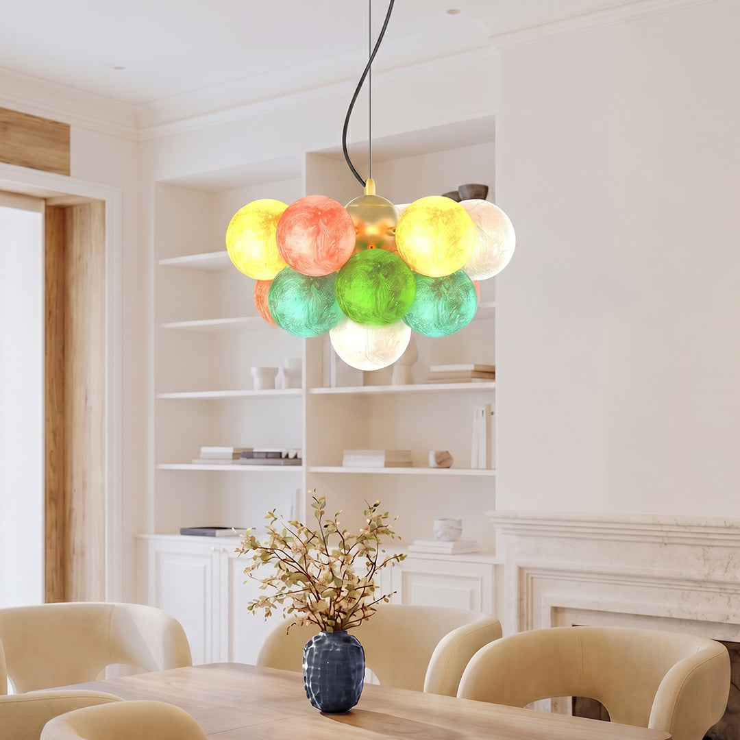 Stained glass chandelier with colorful globe shades hanging in a bright modern living room interior.