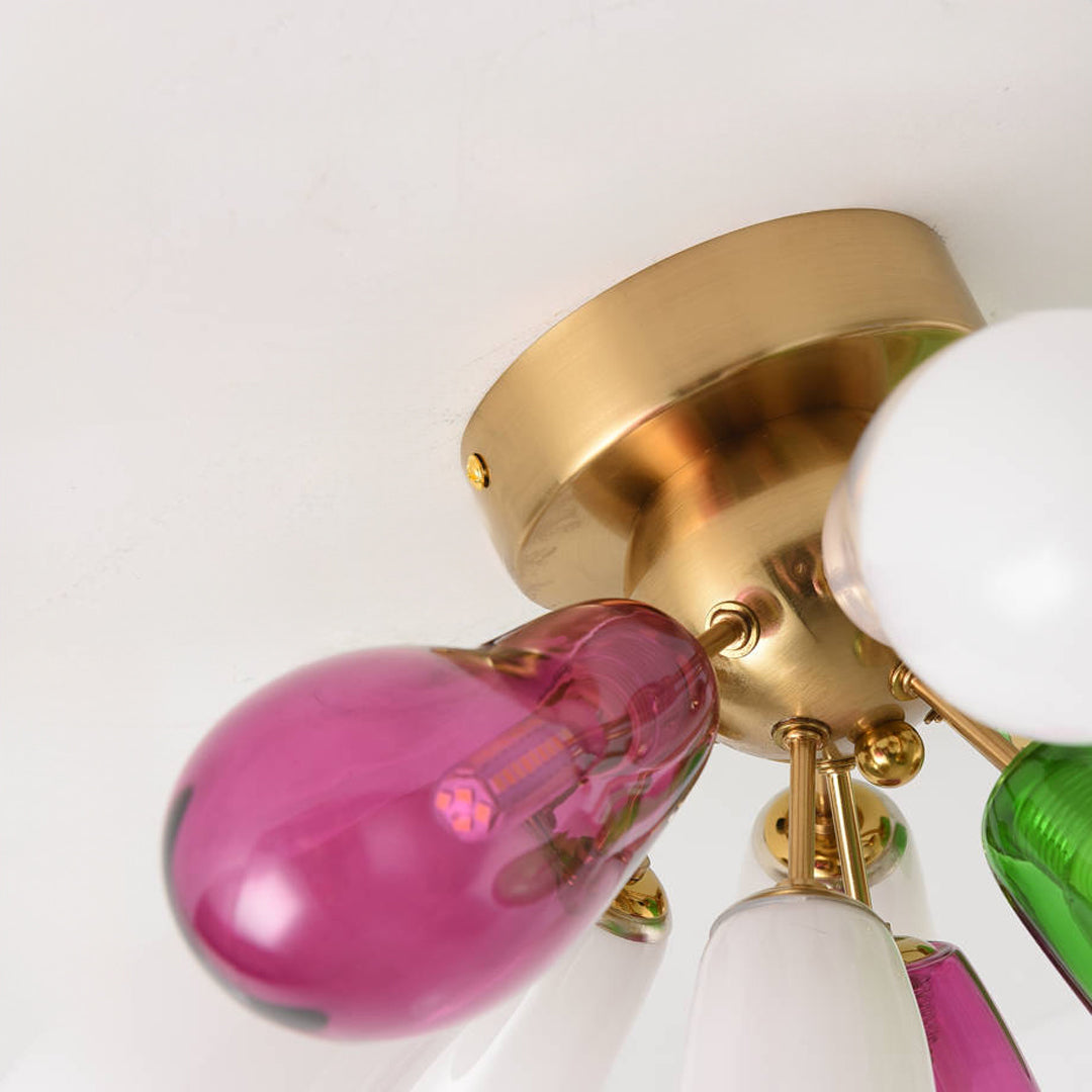 Close-up detail of stained glass bulbs and gold base showing vibrant colors and smooth finish.