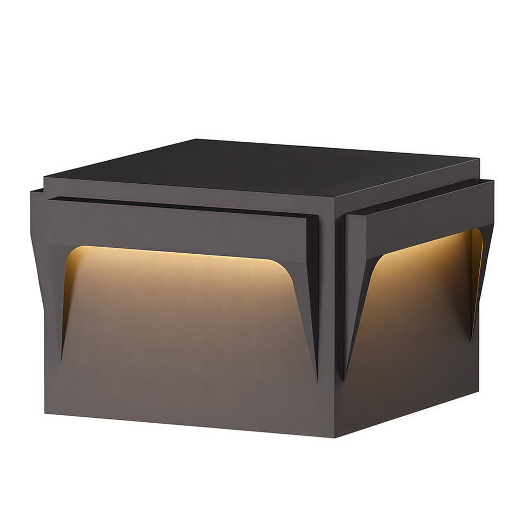 Stainless steel outdoor pillar light with a contemporary design and warm yellow illumination.