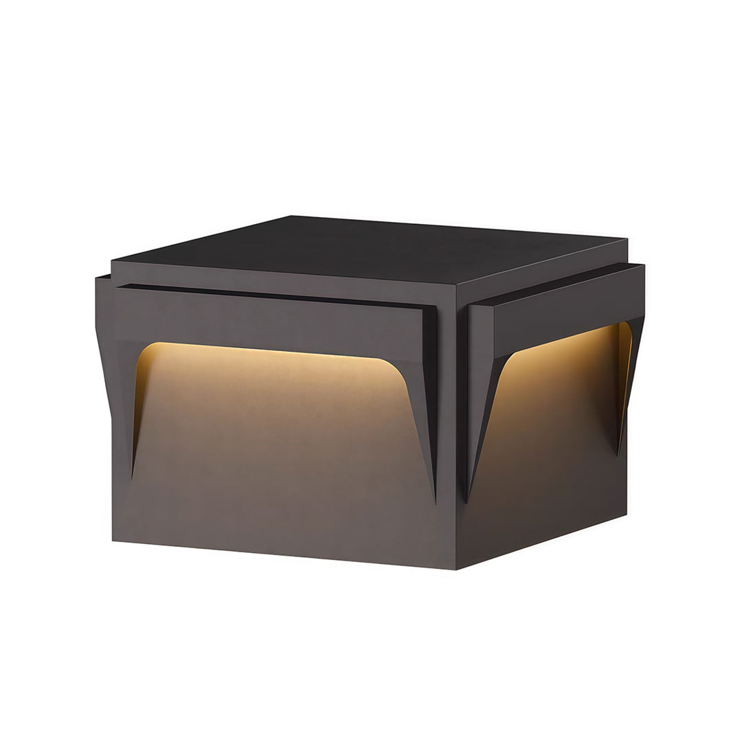 Stainless steel outdoor pillar light with a modern design, featuring a sleek black finish and warm light.