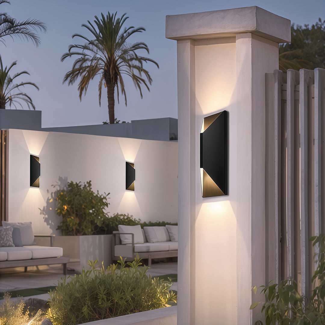 Exterior stainless steel up and down wall light enhancing a modern home façade with warm ambient glow near the entrance path.