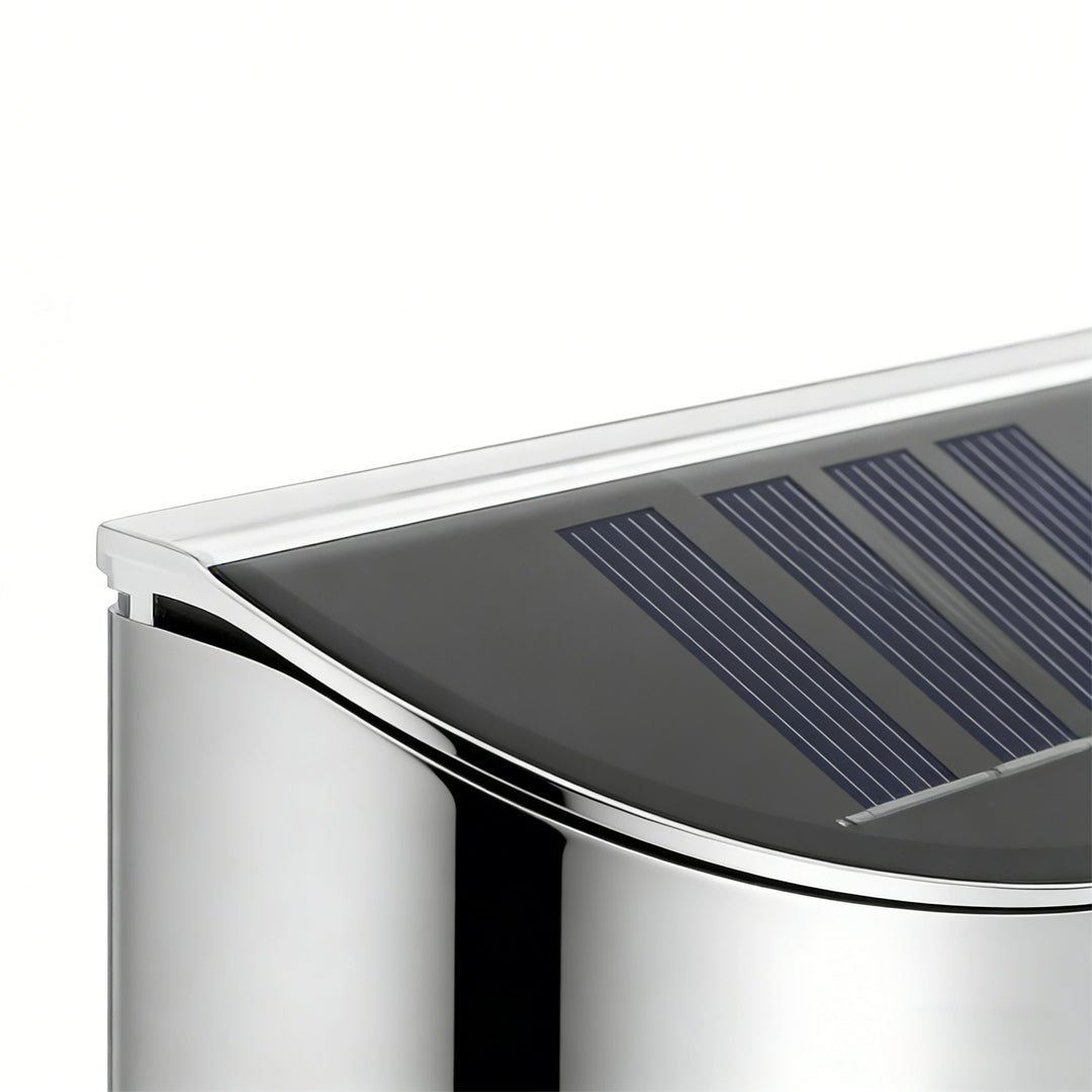 Stainless steel wall lamp with a minimalist design, mounted on a white wall.