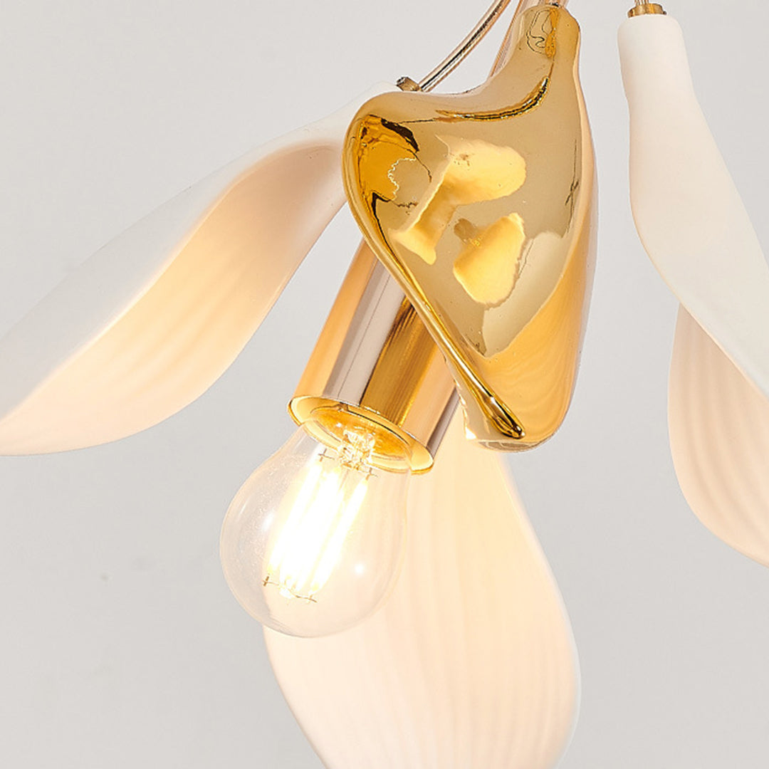 close-up of gold floral chandelier detail with glowing bulb, staircase chandelier ideas