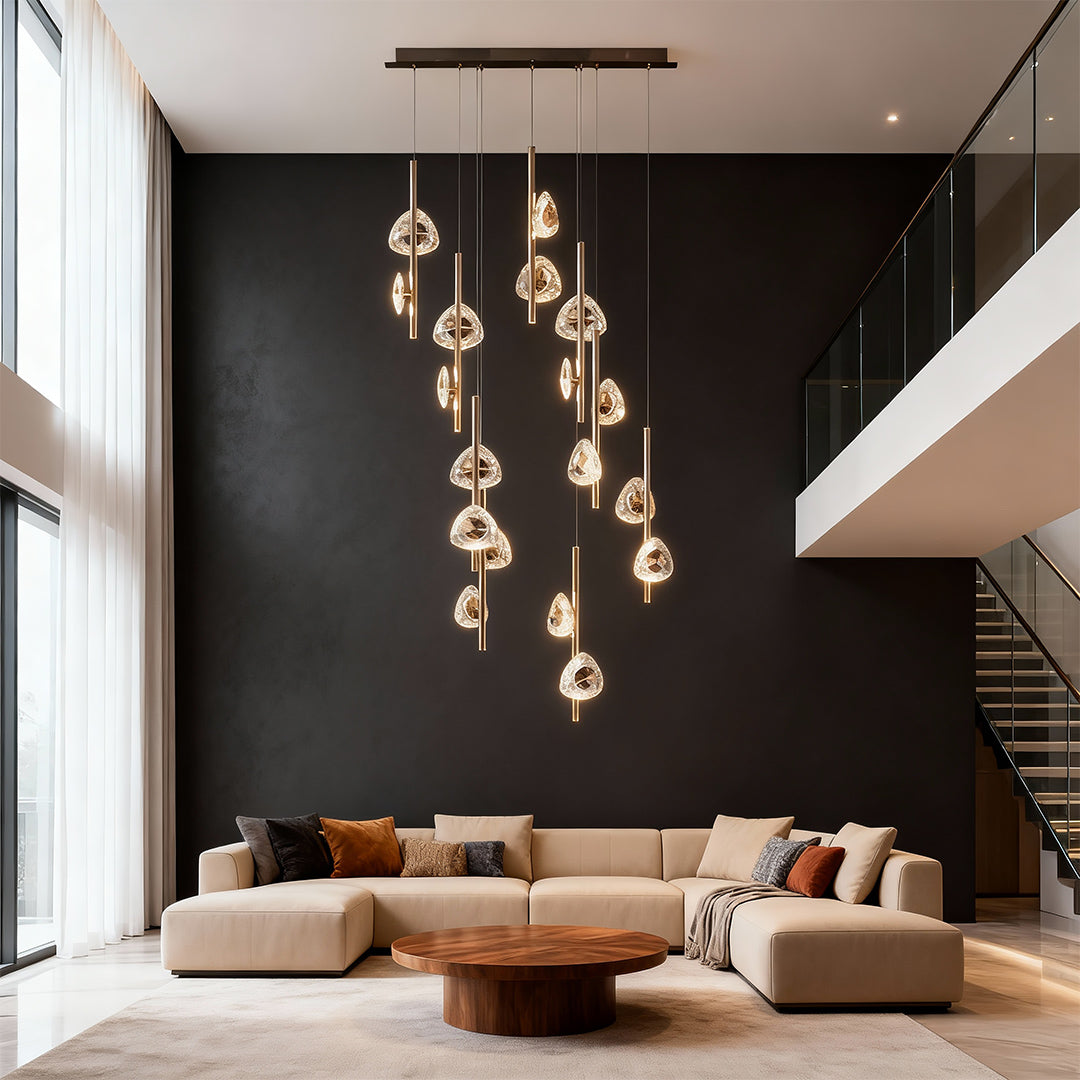 Staircase crystal chandelier cascading against dark accent wall in modern living space with high ceilings and contemporary furnishings
