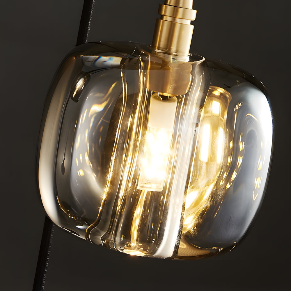 Staircase crystal chandelier with golden accents, illuminating a contemporary staircase.