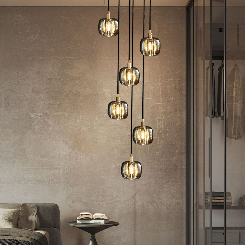 Staircase crystal chandelier with golden crystal drops, providing ambient lighting.