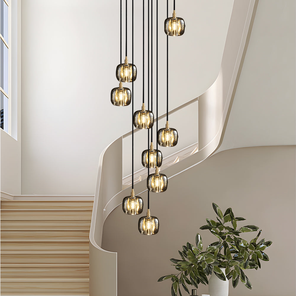 Staircase crystal chandelier with golden accents, providing elegant lighting in a hallway.