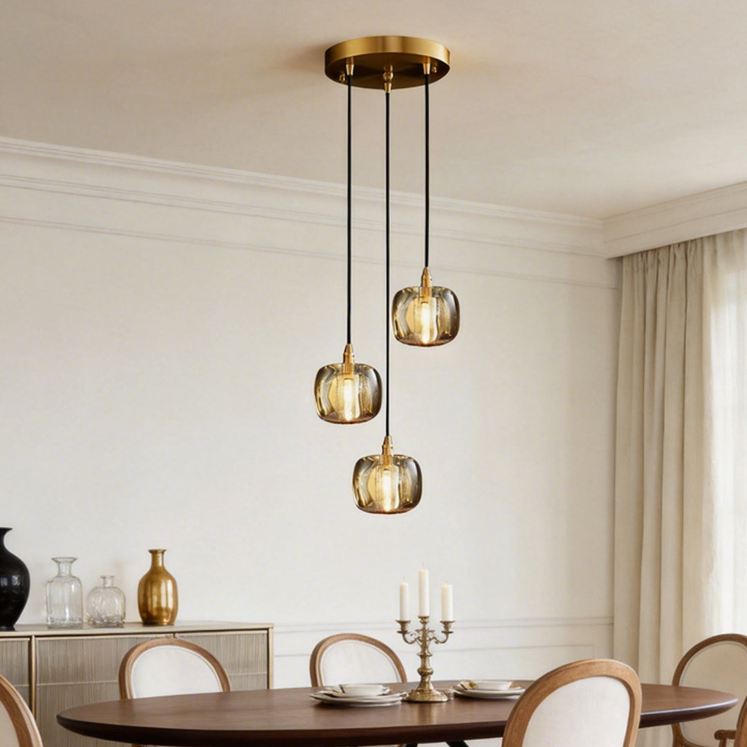 Staircase crystal chandelier with golden accents, hanging above a modern dining table.