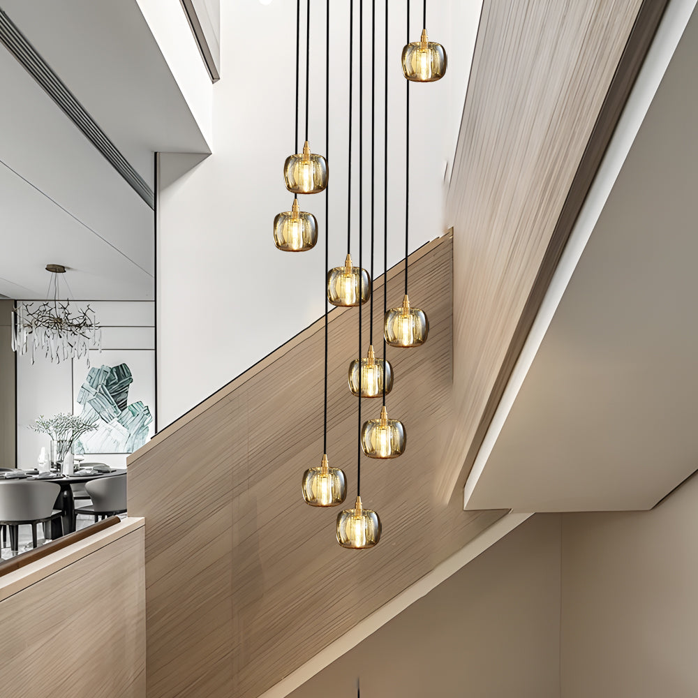 Staircase crystal chandelier with golden accents, enhancing a modern interior.